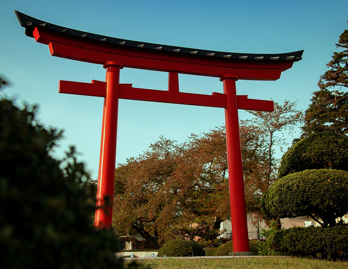 A stunning red torii gate at Onokorojima Shrine in Atsugi, Japan amid lush greenery.