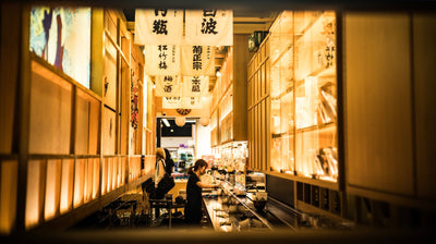 Asian woman working in a Japanese restaurant interior in Sydney, NSW, Australia.