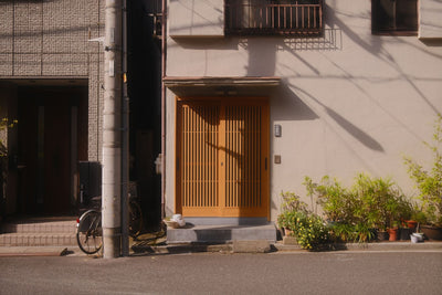 Warm and inviting Japanese house entrance in Tokyo, showcasing traditional architecture.
