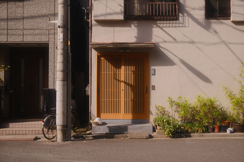 Warm and inviting Japanese house entrance in Tokyo, showcasing traditional architecture.