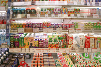 Explore a bustling Tokyo convenience store aisle packed with diverse products and merchandise.
